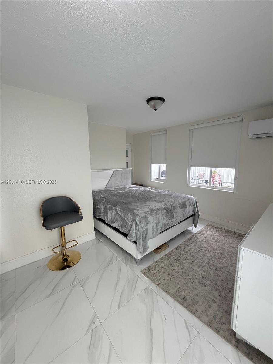 a bedroom with a bed and chair