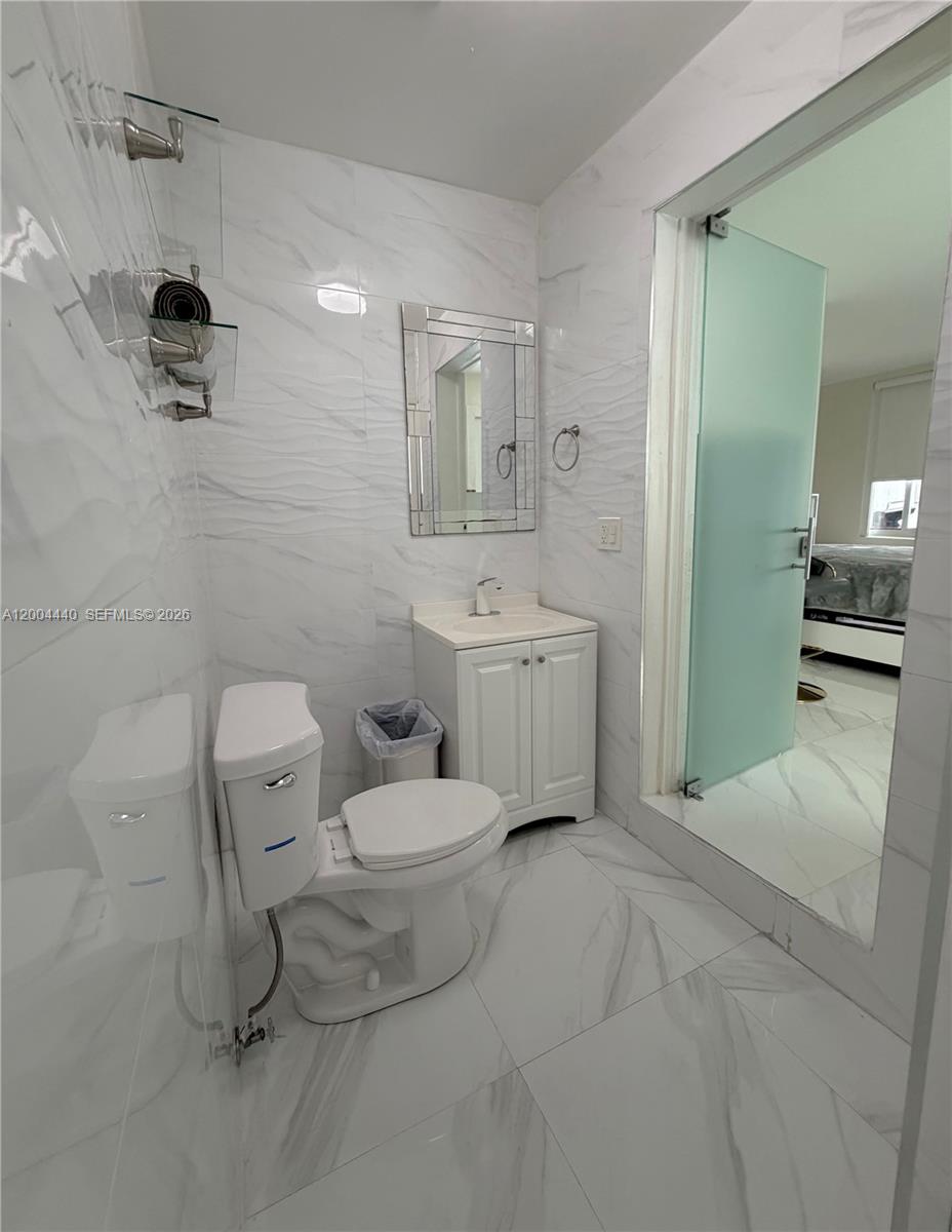 5801 Northwest 113th Terrace, Unit 4 Hialeah, FL 33012 - Photo 7 of 8 a spacious bathroom with a toilet sink and shower