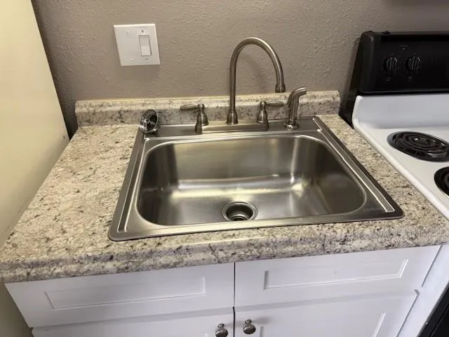 a bathroom with a sink and a microwave