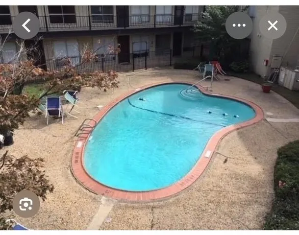 a view of a house with backyard and deck