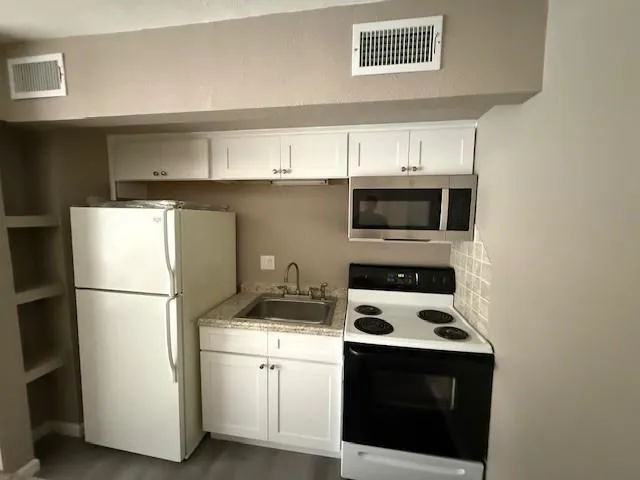 a close view of stove a microwave and a stove