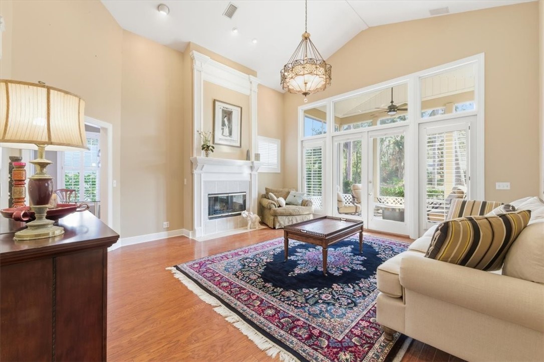 805 King's Grant St. Simons Island, GA 31522 - Photo 21 of 50 High vaulted ceilings, a fireplace, wood floors, double doors to screened-in back porch - what more could you ask for?