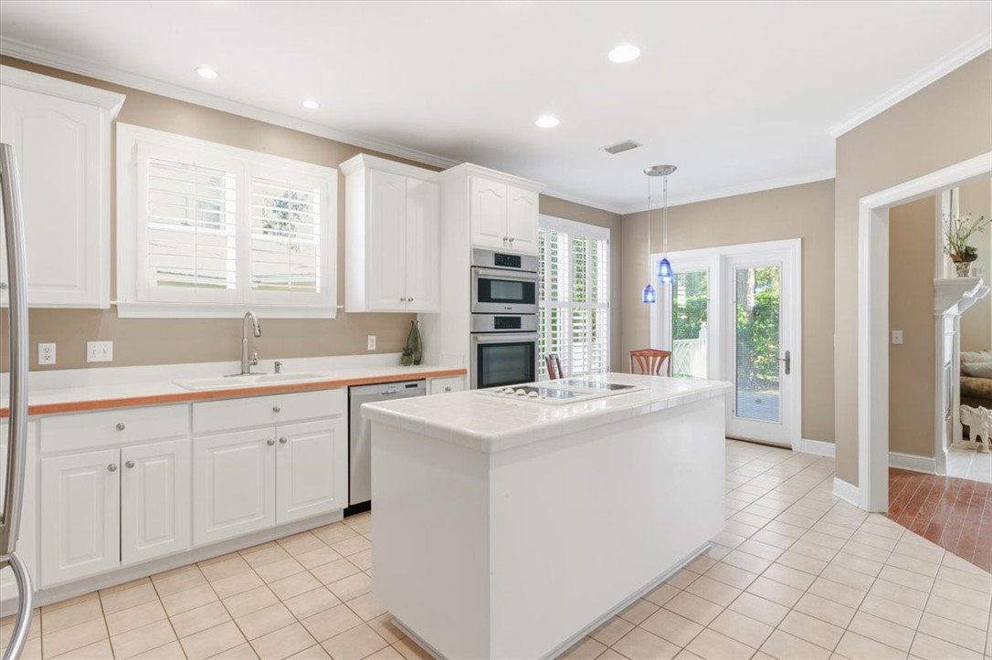 805 King's Grant St. Simons Island, GA 31522 - Photo 8 of 50 The kitchen is very spacious with a large work area. The doors open to the rear deck.