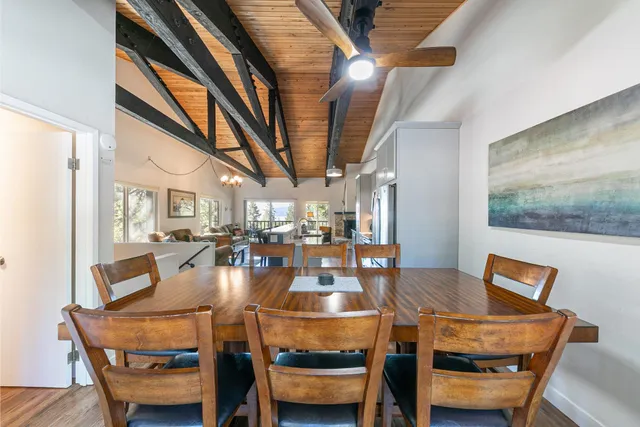 a dining room with furniture a rug and wooden floor