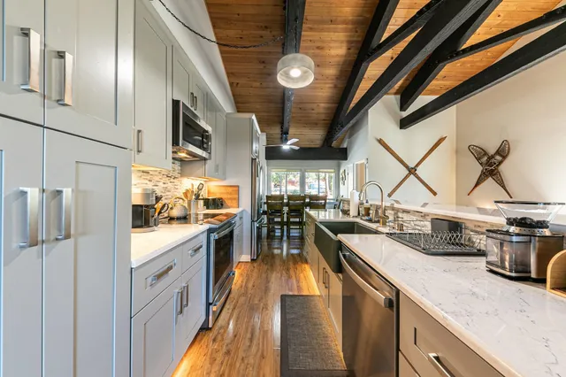 a kitchen with stainless steel appliances granite countertop lots of counter top space