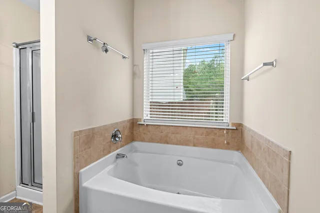 a white bath tub sitting next to a window