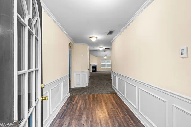 a view of a hallway view with wooden floor and staircase
