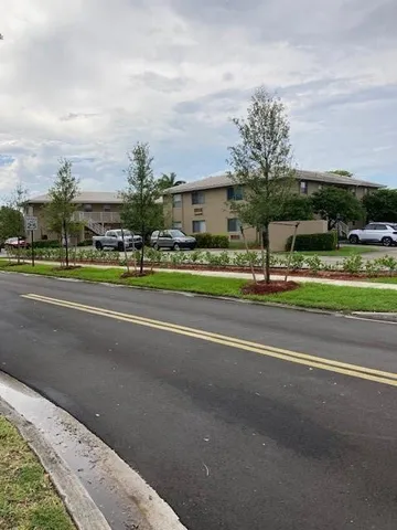 a view of street with houses and trees in the background