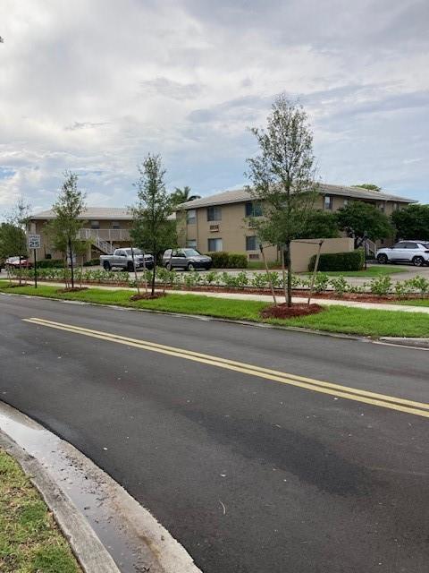 a view of street with houses and trees in the background