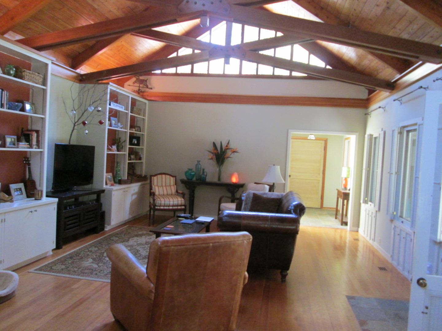 10 Palm Circle Road Woodside, CA 94062 - Photo 4 of 12 a living room with furniture a flat screen tv and a chandelier