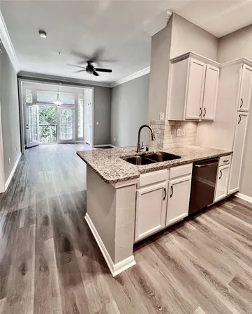 a kitchen with a sink window and cabinets