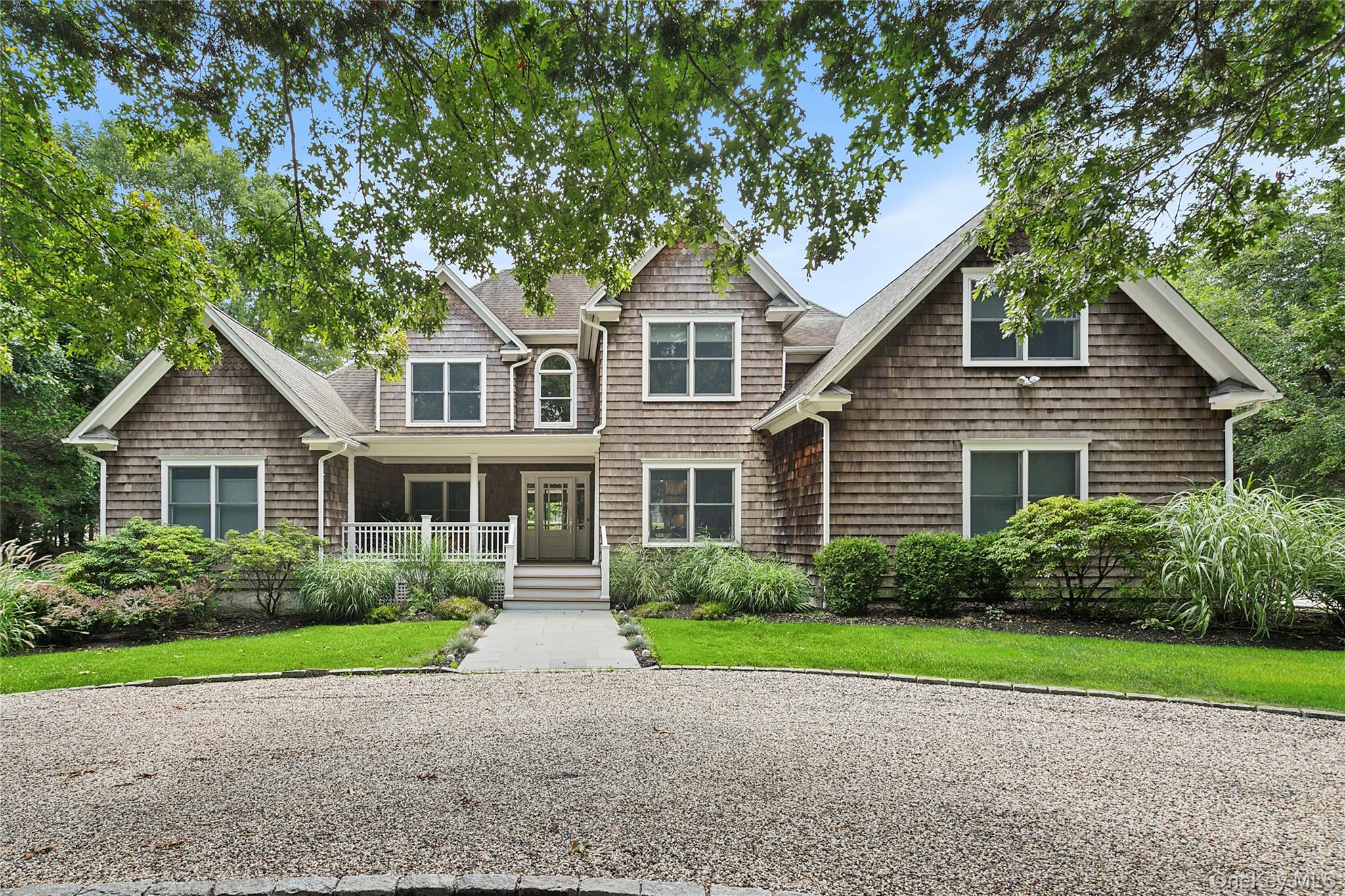 3470 North Bayview Road Southold, NY 11971 - Photo 1 of 25 View of front facade featuring covered porch and a front lawn
