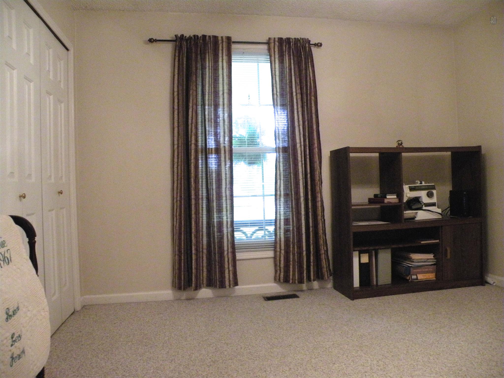304 Haynes Road Portland, TN 37148 - Photo 18 of 21 a view of an empty room with a fireplace and a window