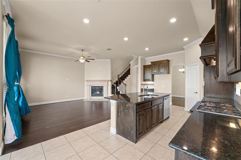 600 Fishback Circle Plano, TX 75074 - Photo 28 of 38 a kitchen with granite countertop a stove and a sink