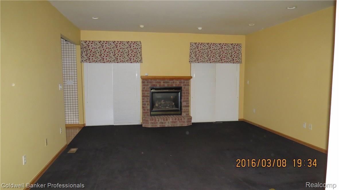 16200 33 Mile Road Armada, MI 48005 - Photo 21 of 77 Gas Fireplace with Shades Down on Door Wall Entrance to Breakfast Nook and Kitchen to the Left