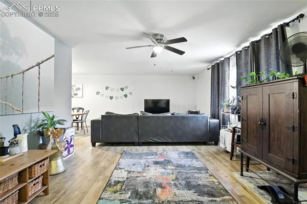 a bedroom with furniture and a wooden floor