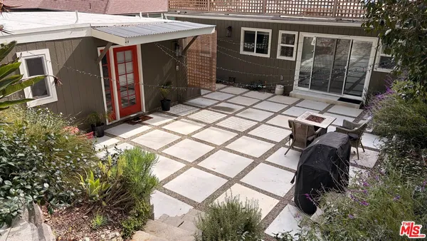 a backyard of a house with barbeque oven fire pit and outdoor seating