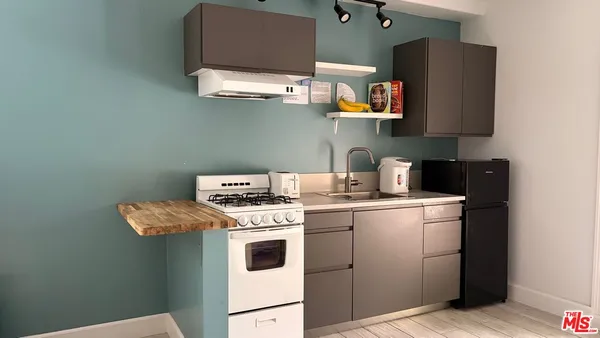 a utility room with dryer washer and sink