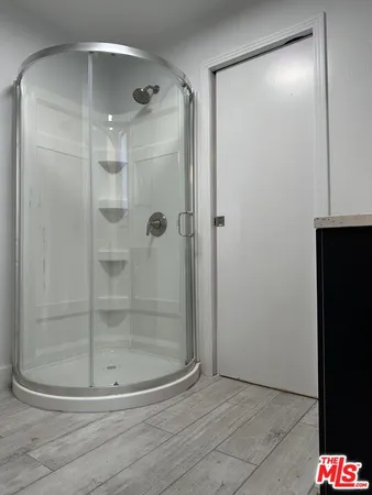 a bathroom with a glass shower door