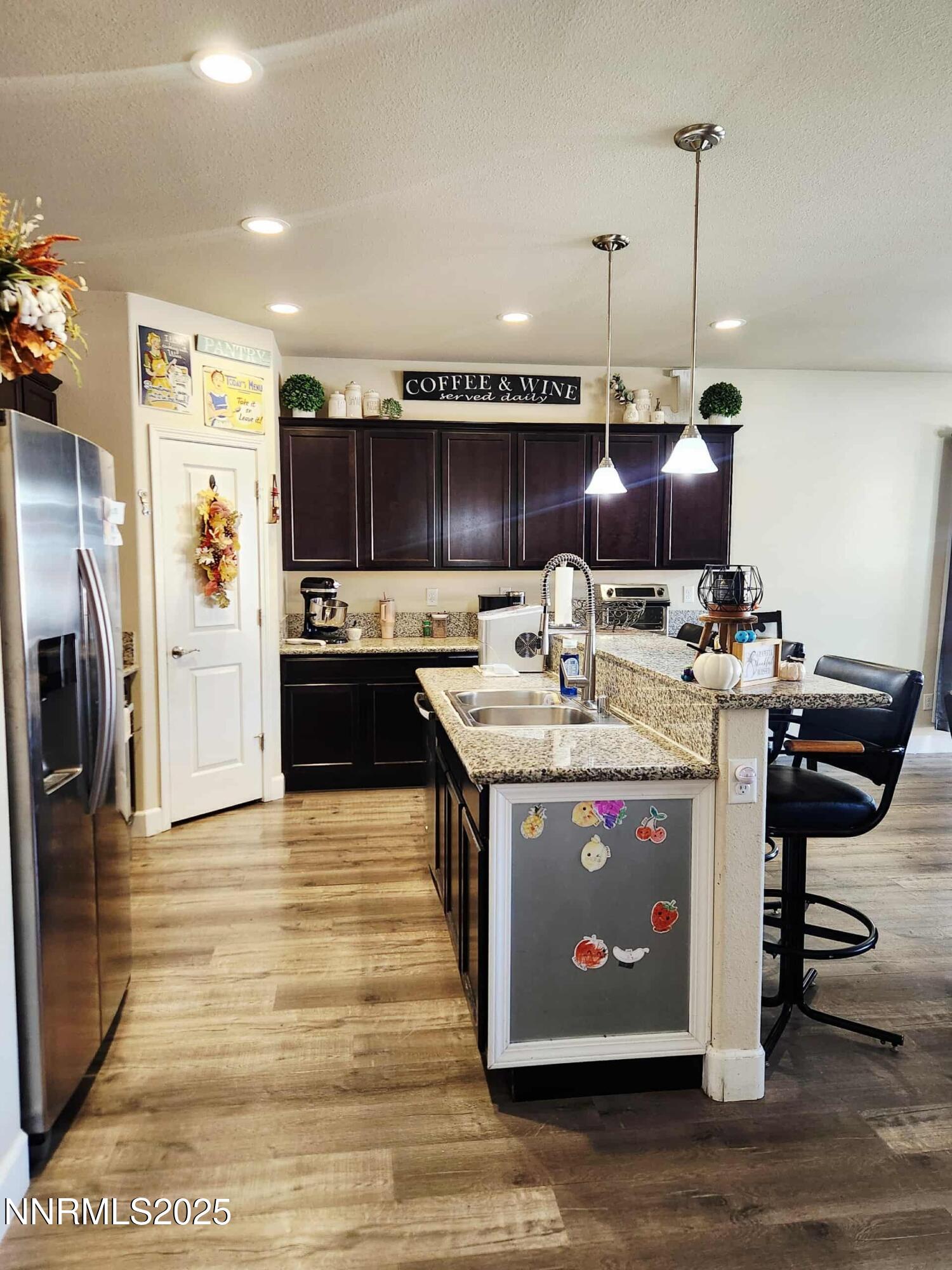 203 Verre Court Dayton, NV 89403 - Photo 15 of 28 a view of kitchen with stainless steel appliances granite countertop a stove and a refrigerator