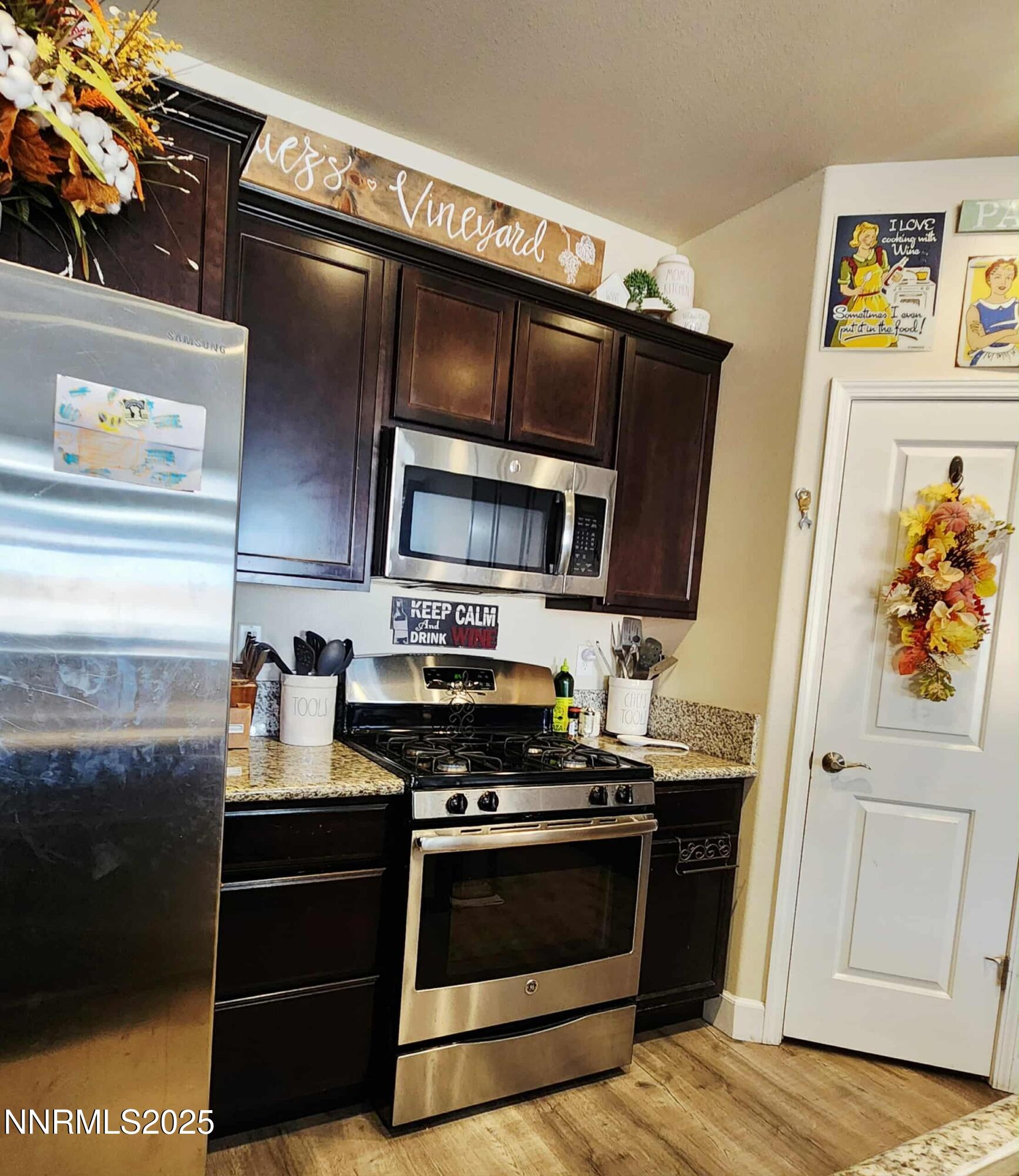 203 Verre Court Dayton, NV 89403 - Photo 16 of 28 a kitchen with stainless steel appliances a stove and a microwave