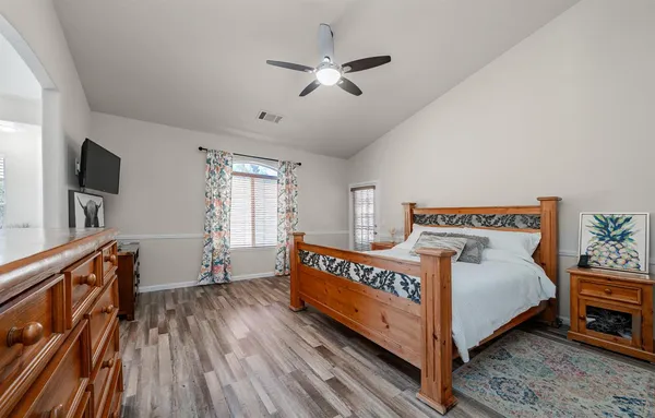 a bedroom with a bed and a tv on the dresser