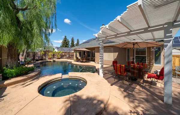a view of a swimming pool with sitting area