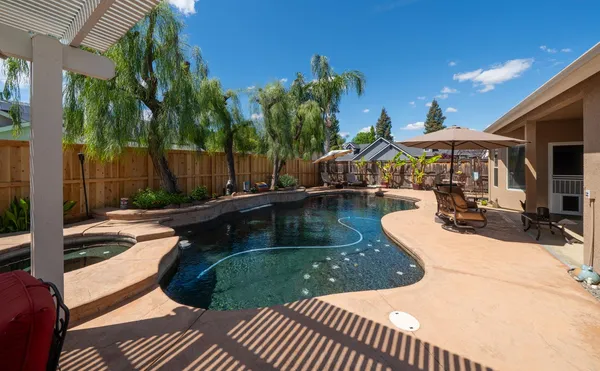 a view of a swimming pool with a patio
