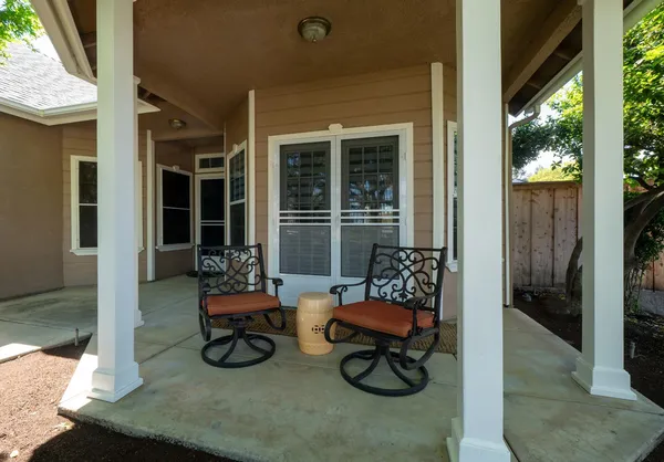a building outdoor space with patio furniture and potted plants