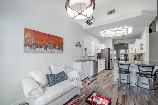a living room with furniture and kitchen view