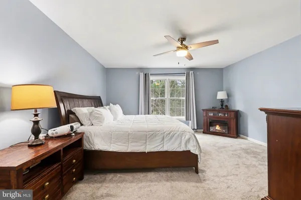 a bedroom with a bed and a lamp on table