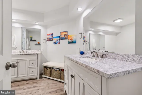 a bathroom with a granite countertop sink and a mirror