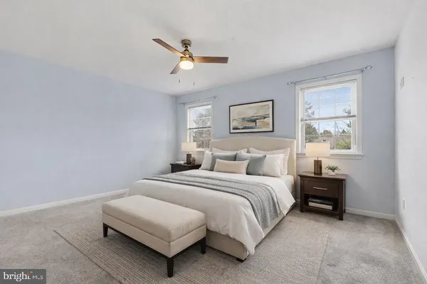 a bedroom with a bed lamp and a window