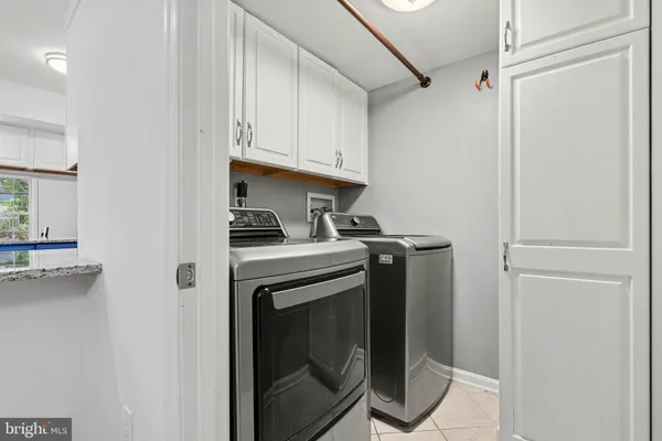a view of washer and dryer with kitchen in the background