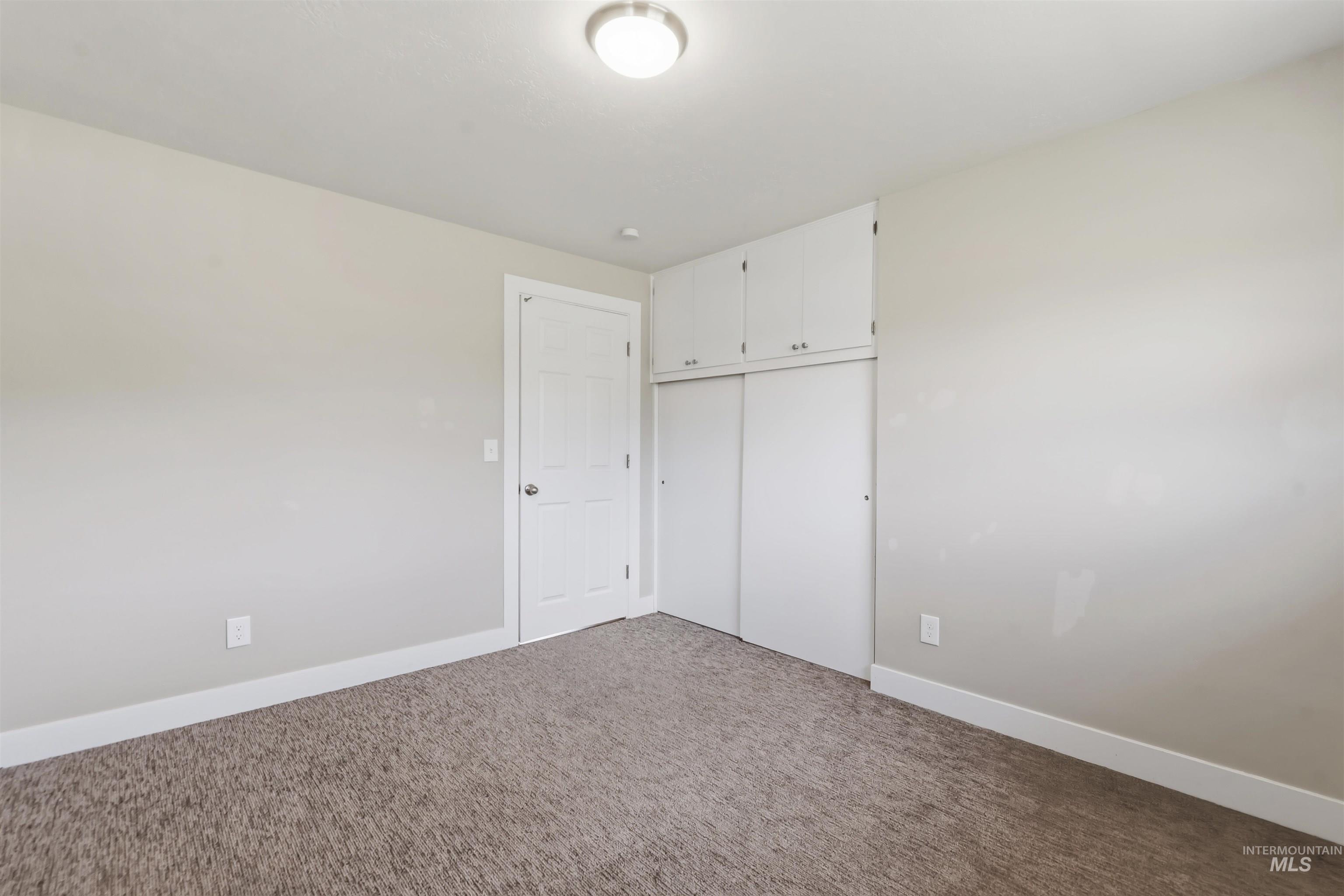 355 East Beacon Light Road Eagle, ID 83616 - Photo 18 of 47 Bedroom featuring light gray wall paint, brown carpet flooring, and white trim