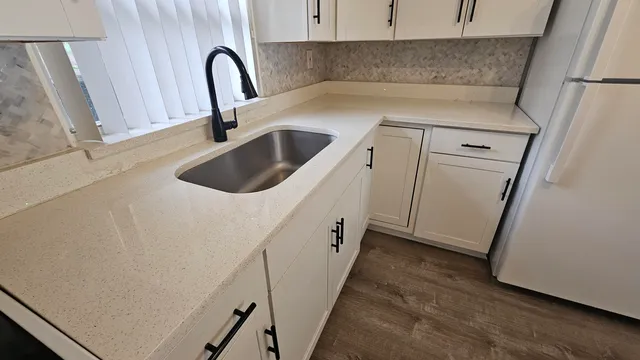 a kitchen with a sink and a refrigerator
