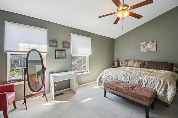 a bedroom with furniture and a flat screen tv