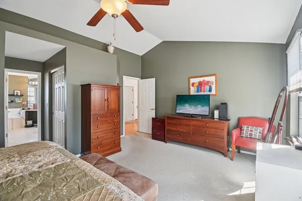 a view of a hallway with wooden floor and a livingroom