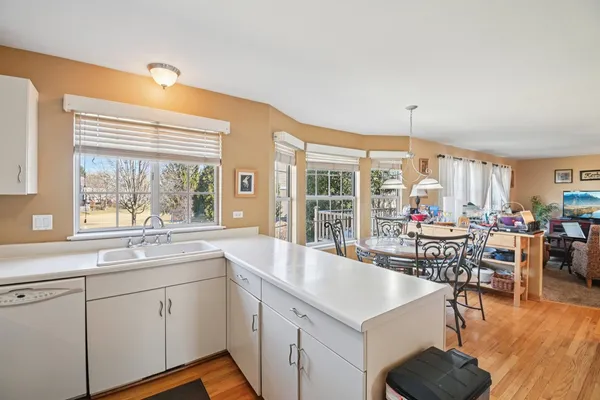 a large white kitchen with a large window