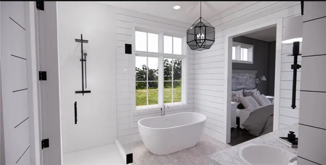 a bathroom with a tub sink and mirror