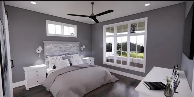 a bedroom with a bed and a large window
