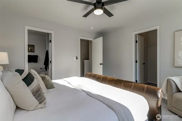 a bedroom with a bed and a chandelier