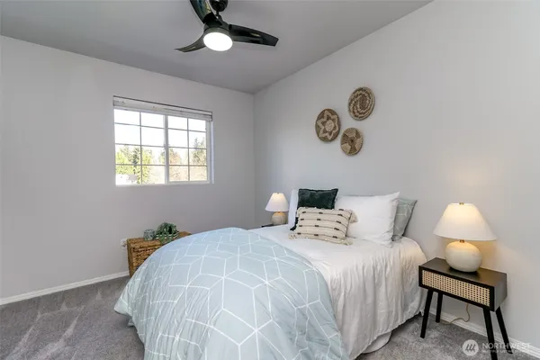 a bedroom with a bed and a window