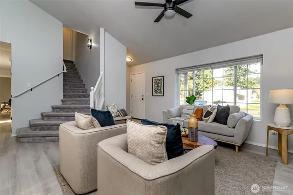 a living room with furniture and a large window