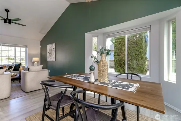 a dining room with furniture and wooden floor