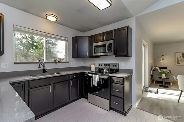 a kitchen with a sink stove and microwave