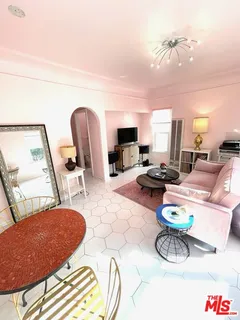 a dining room with furniture a rug and a chandelier