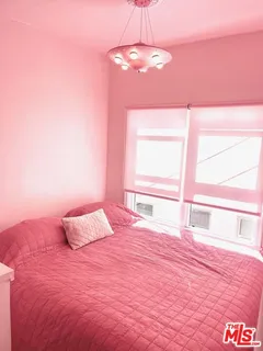an empty room with wooden floor and mirror