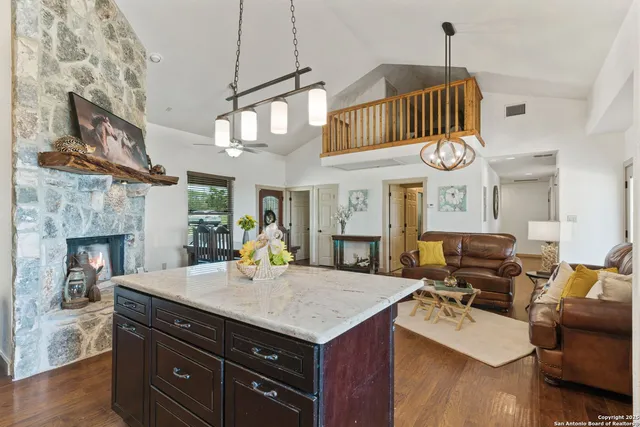 a kitchen with a stove cabinets and wooden floor