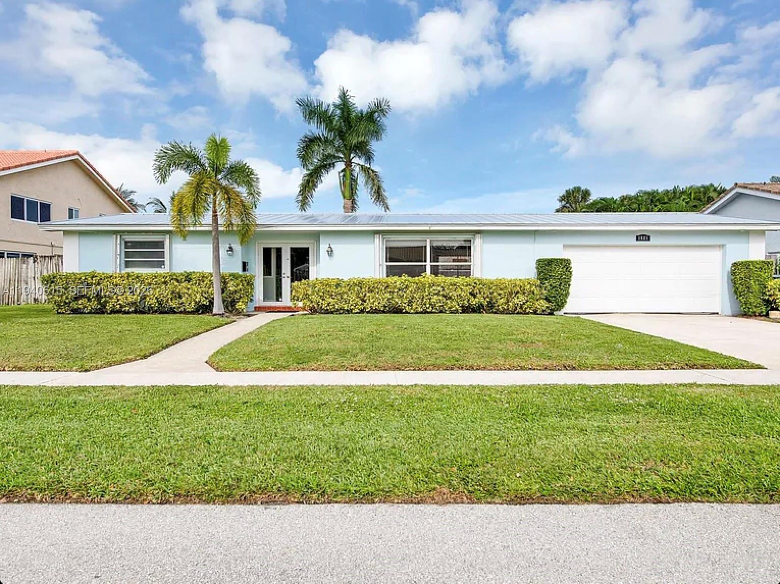 1521 Southwest 14th Street Boca Raton, FL 33486 - Photo 3 of 6 a front view of house with yard and green space